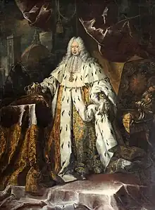 A peri-wigged man is resplendent in gold, ermine-fringed coronation robes. The man holds the royal sceptre of Tuscany in his right hand; at the same time clenching the royal crown. The cross of the order of Saint Stephen Pope and Martyr adorns his neck. The Cathedral of Santa Maria del Fiore lies crumbling against a dark sky outside the window.